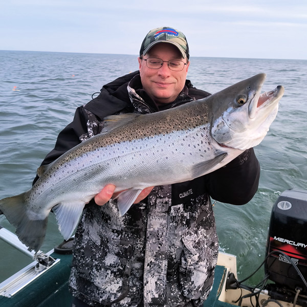 man holding a big fish on lake ontario
